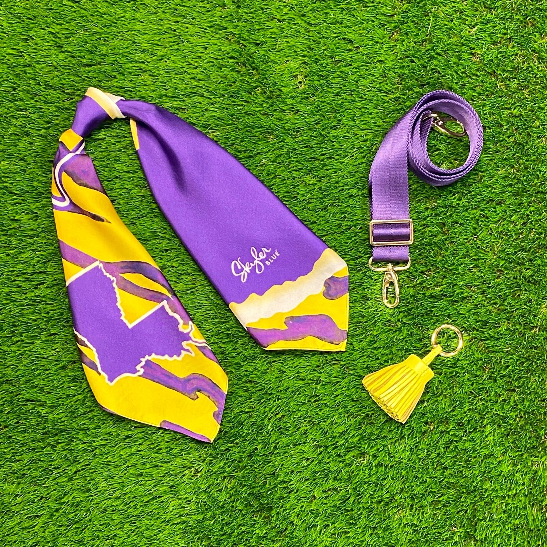 Skyler Blue’s The Baton Rouge Accessory Package including adjustable, nylon webbing shoulder or crossbody strap with herringbone weave and gold hardware, 60-centimeter 100% silk twill scarf, and 100% genuine leather tassel.