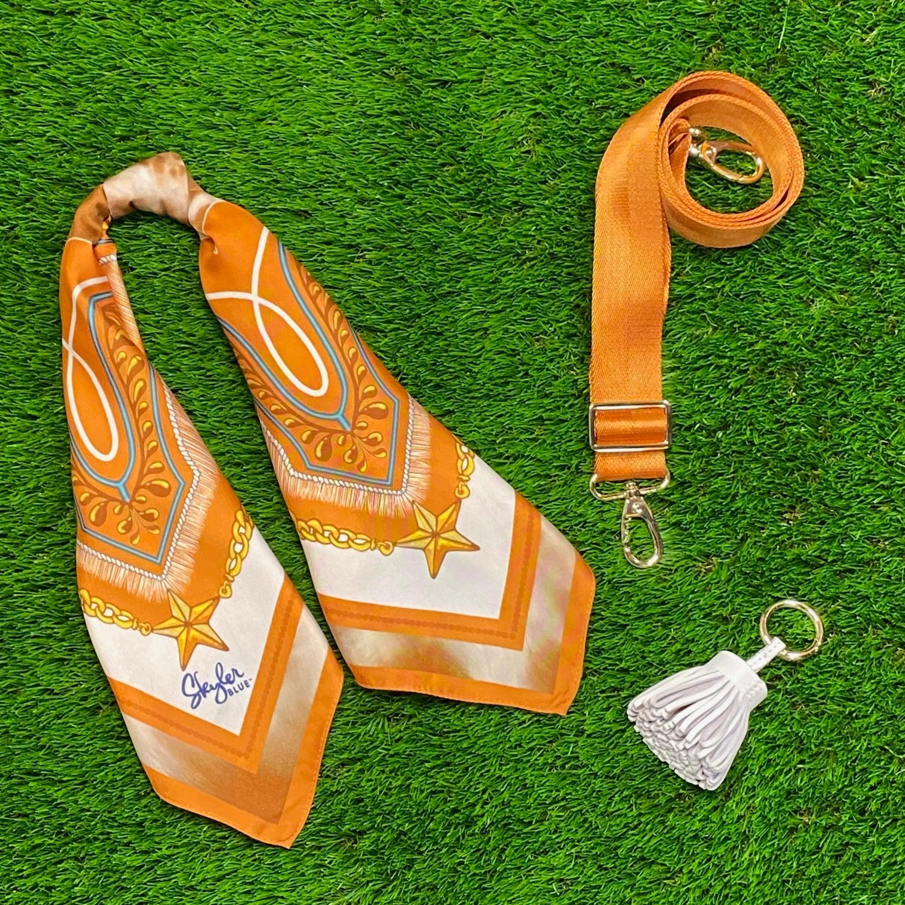 Skyler Blue’s The Austin 001 Accessory Package including adjustable, nylon webbing shoulder or crossbody strap with herringbone weave and gold hardware, 60-centimeter 100% silk twill scarf, and 100% genuine leather tassel.