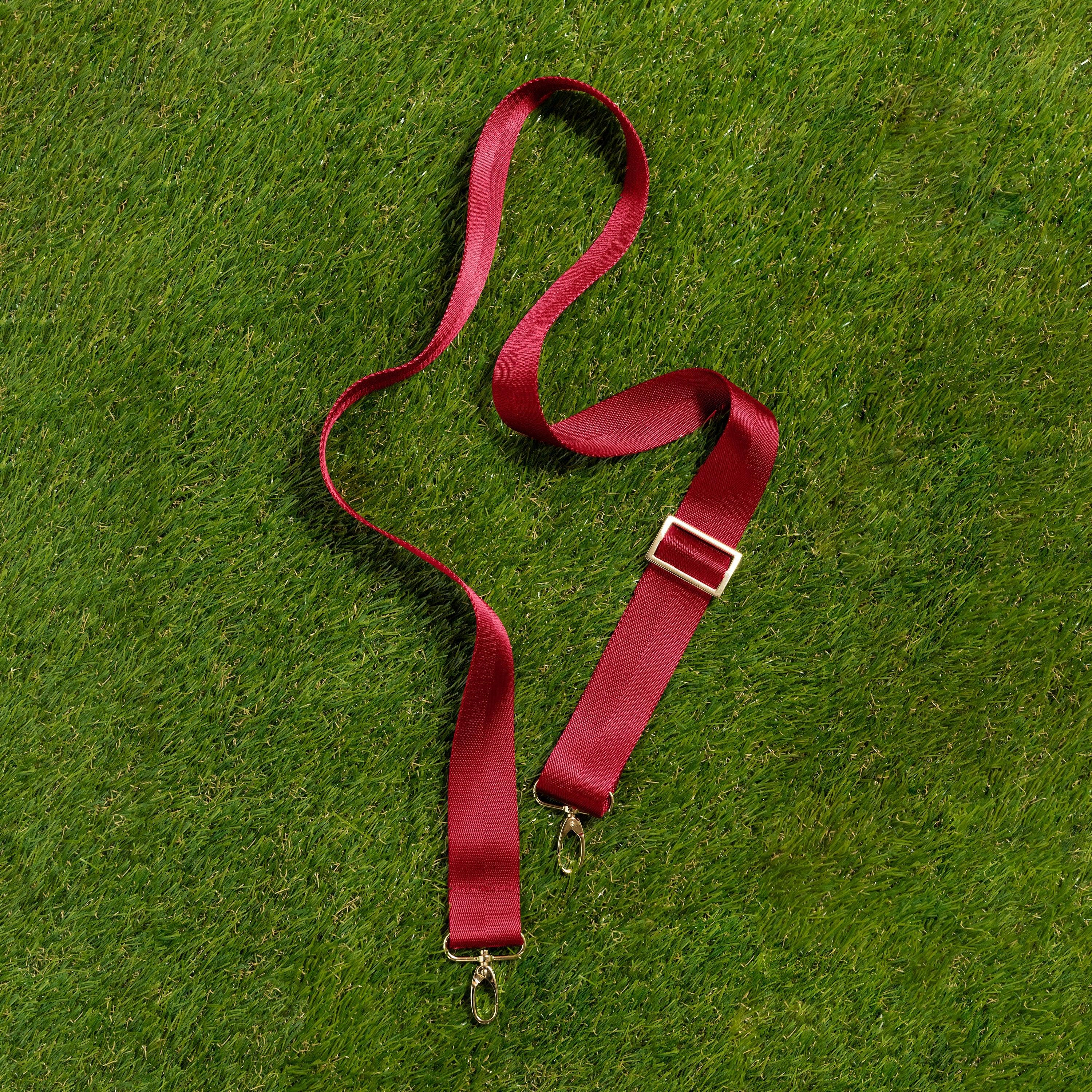 Skyler Blue’s adjustable, nylon webbing crimson red fanny pack strap with herringbone weave and gold hardware.