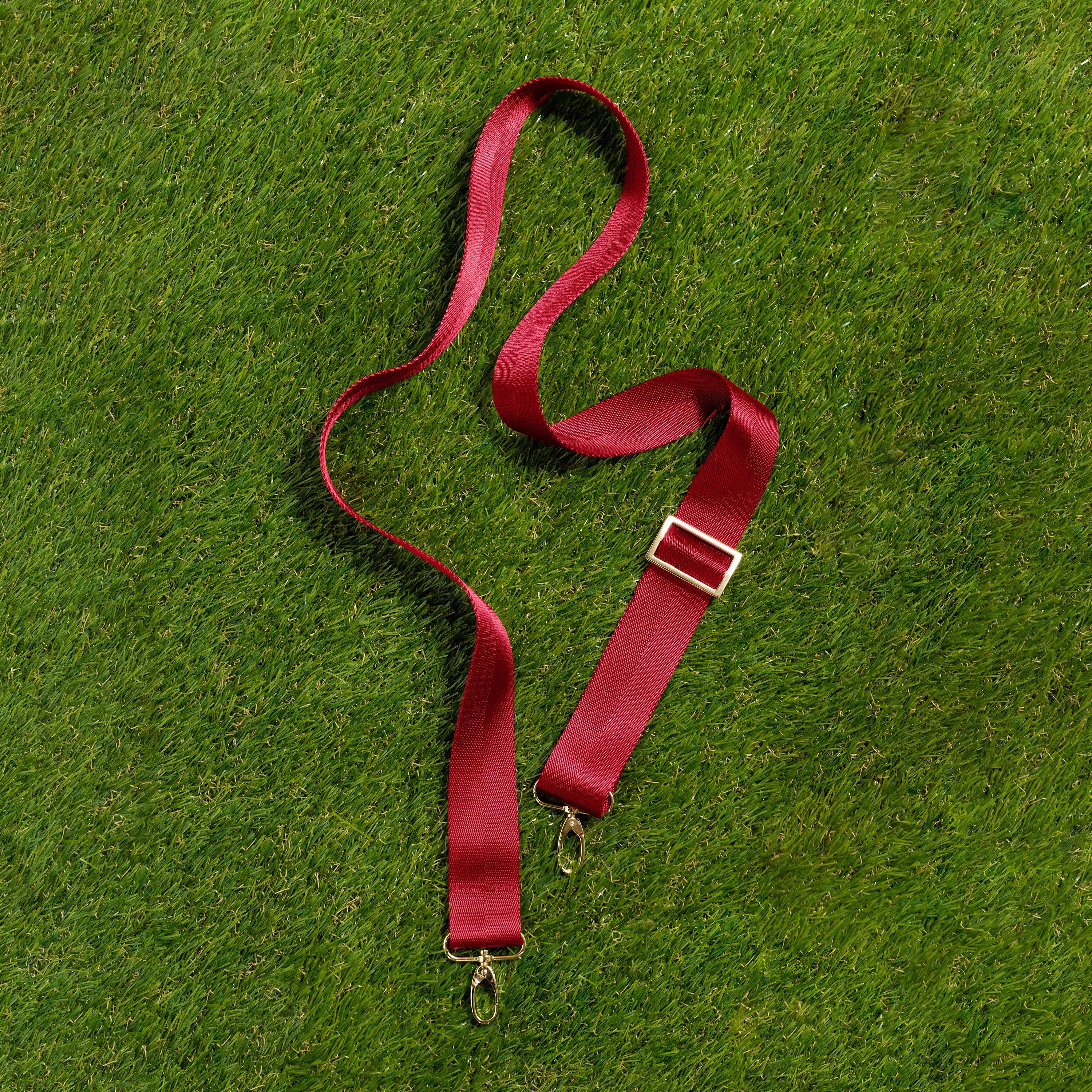 Skyler Blue’s adjustable, nylon webbing crimson red shoulder or crossbody strap with herringbone weave and gold hardware.