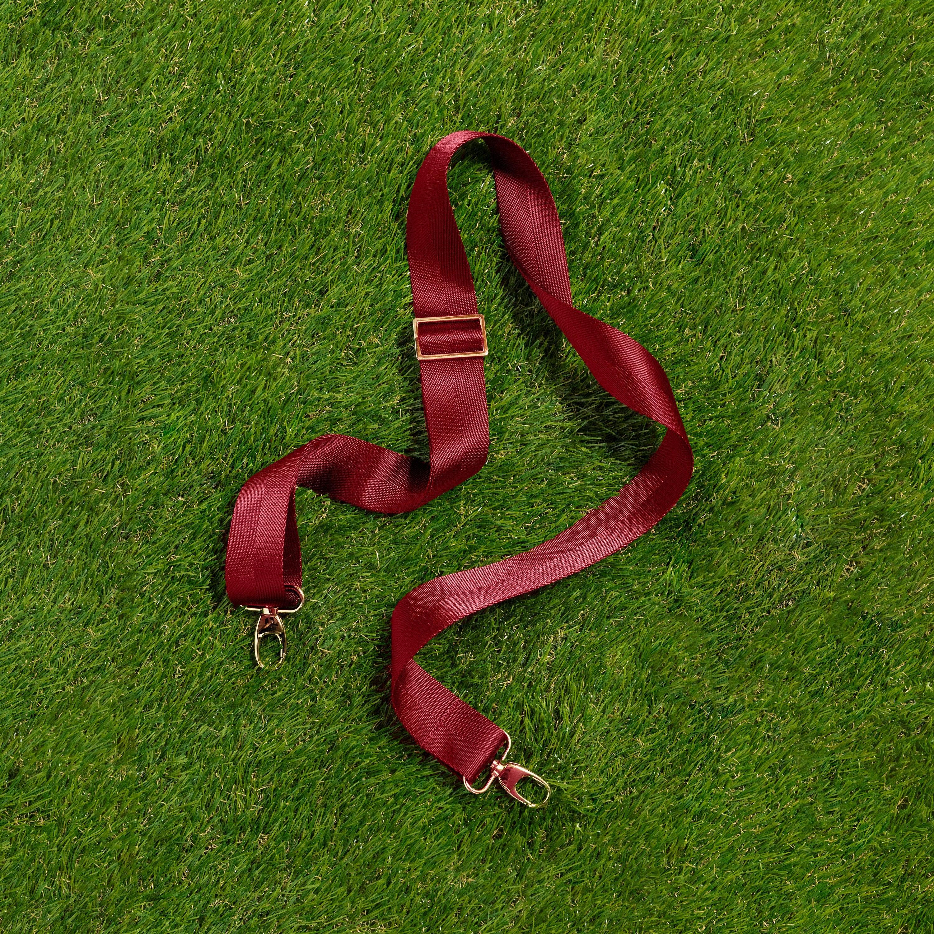 Skyler Blue’s adjustable, nylon webbing garnet red fanny pack strap with herringbone weave and gold hardware.
