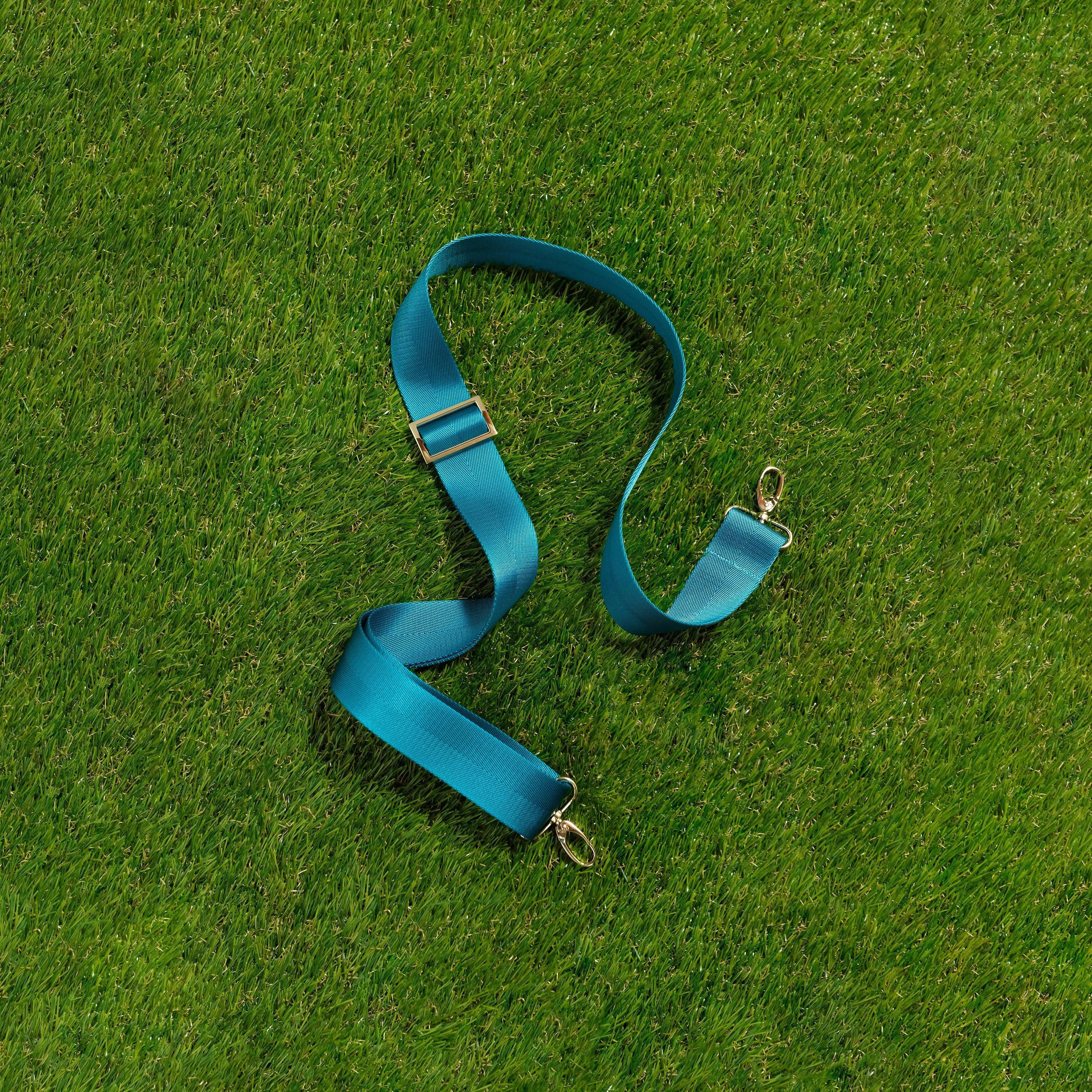 Skyler Blue’s adjustable, nylon webbing teal fanny pack strap with herringbone weave and gold hardware.