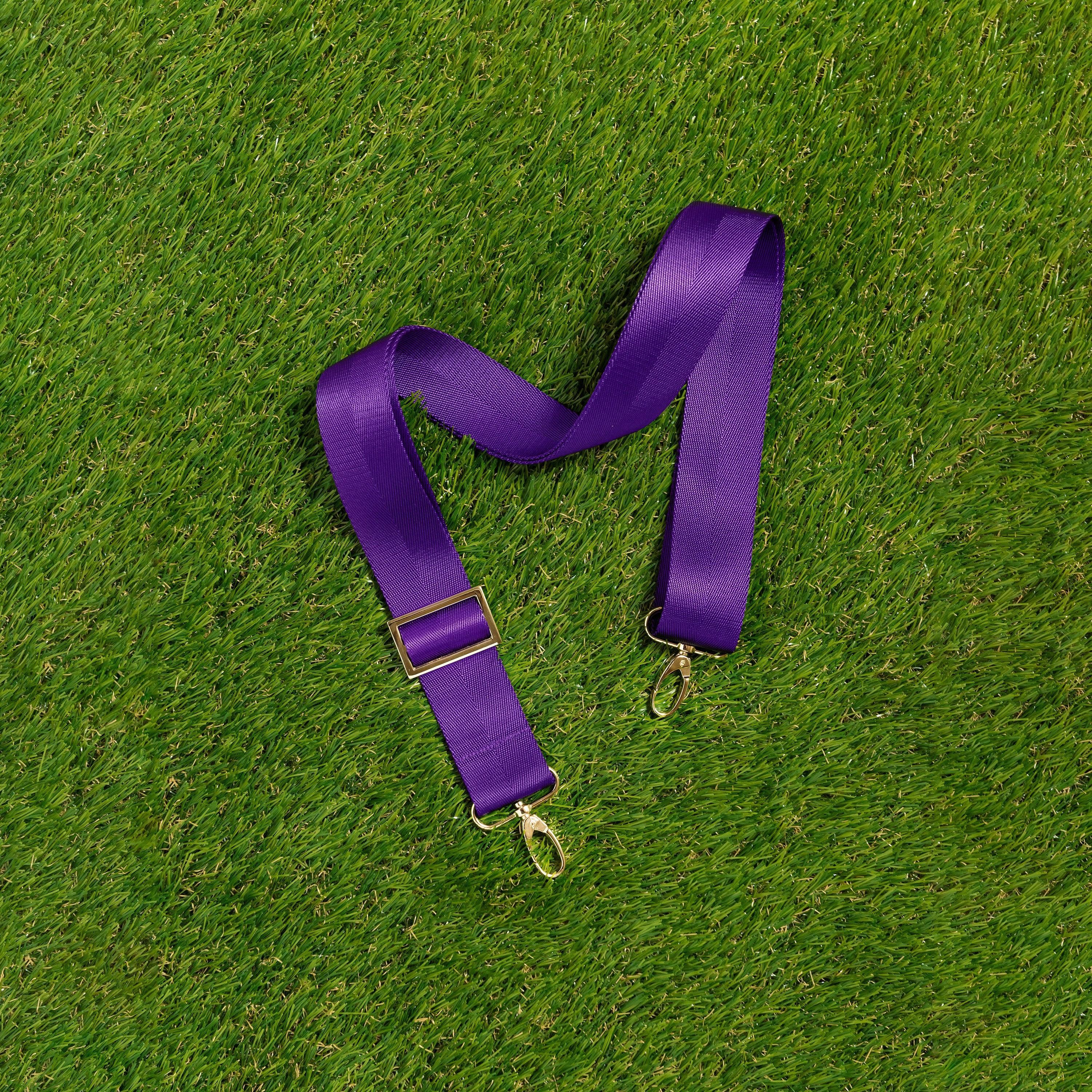 Skyler Blue’s adjustable, nylon webbing purple shoulder or crossbody strap with herringbone weave and gold hardware.