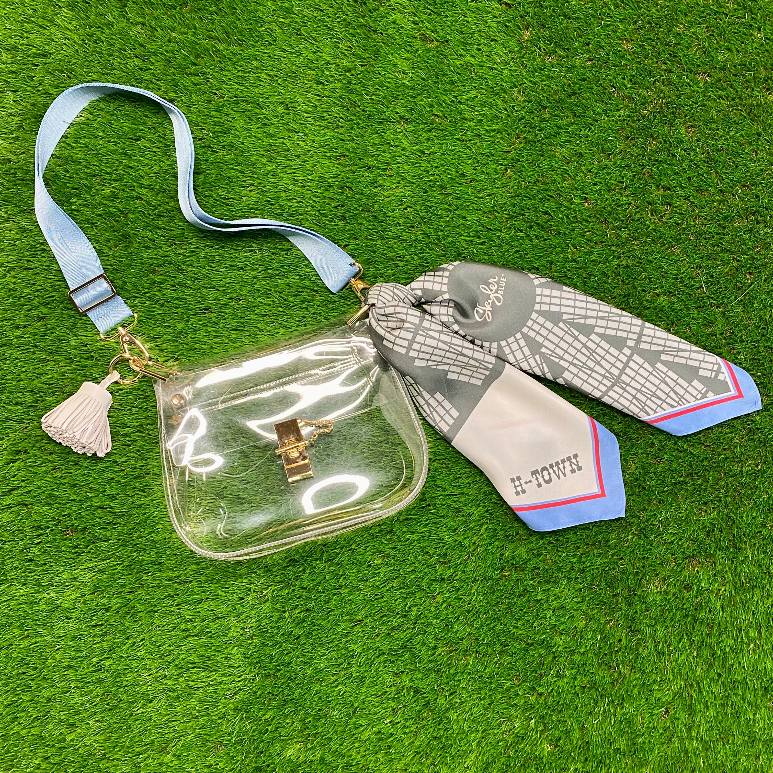 Skyler Blue’s The Dome - H-Town Medium Saddle Clear Bag stadium approved clear bag / clear purse including adjustable, nylon webbing shoulder or crossbody strap with herringbone weave and gold hardware, 60-centimeter 100% silk twill scarf, and 100% genuine leather tassel.