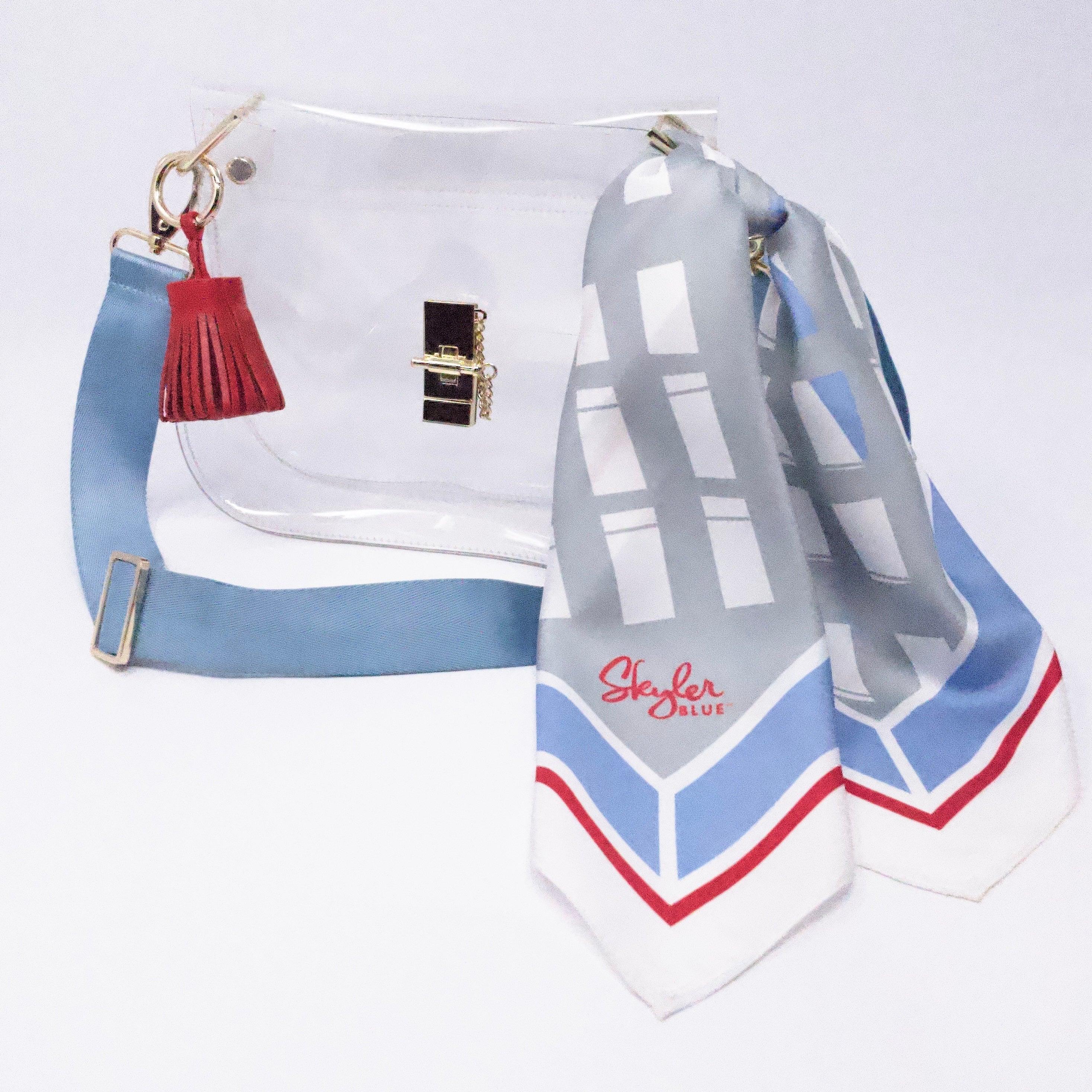 Skyler Blue’s The Dome - Luv Ya Medium Saddle Clear Bag stadium approved clear bag / clear purse including adjustable, nylon webbing shoulder or crossbody strap with herringbone weave and gold hardware, 60-centimeter 100% silk twill scarf, and 100% genuine leather tassel.