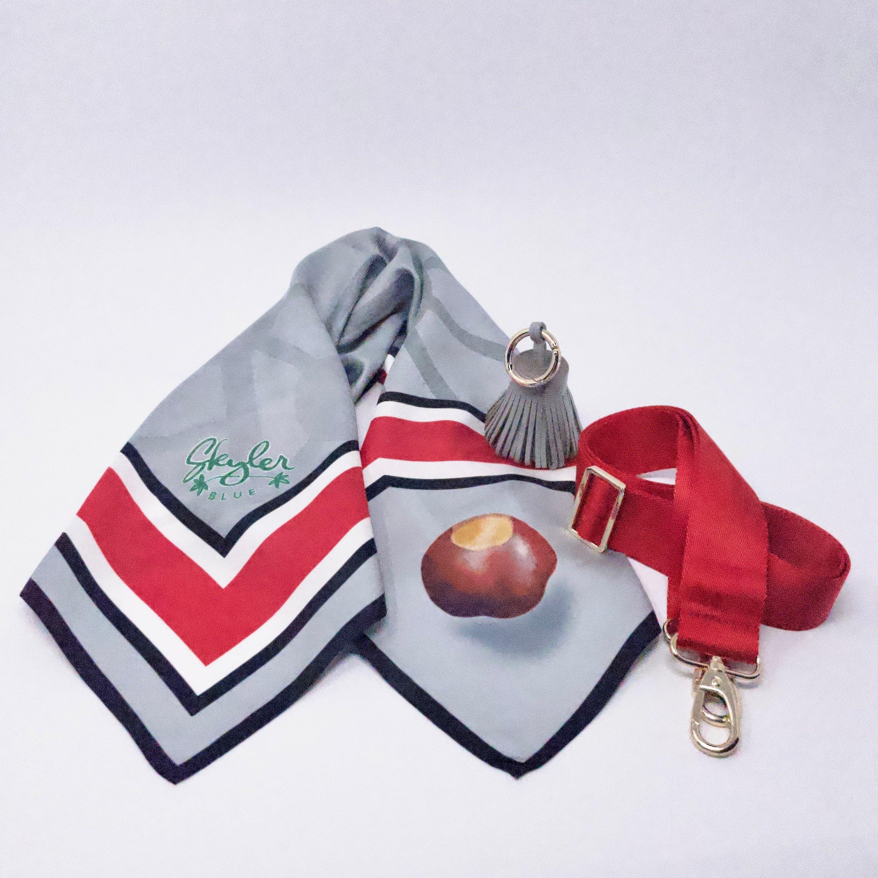 Skyler Blue’s The Columbus Accessory Package including adjustable, nylon webbing shoulder or crossbody strap with herringbone weave and gold hardware, 60-centimeter 100% silk twill scarf, and 100% genuine leather tassel.