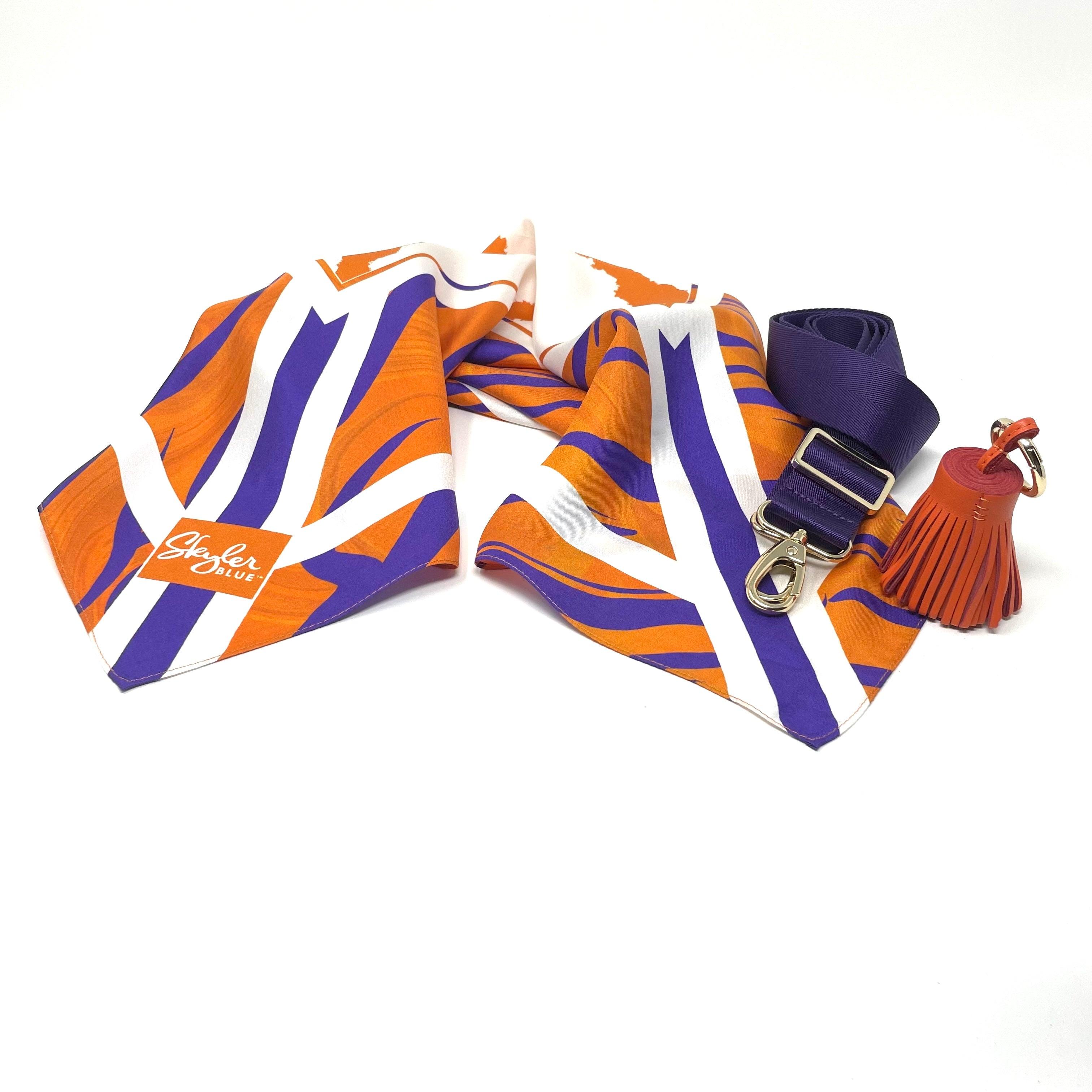 Skyler Blue’s The Howard Accessory Package including adjustable, nylon webbing shoulder or crossbody strap with herringbone weave and gold hardware, 60-centimeter 100% silk twill scarf, and 100% genuine leather tassel.