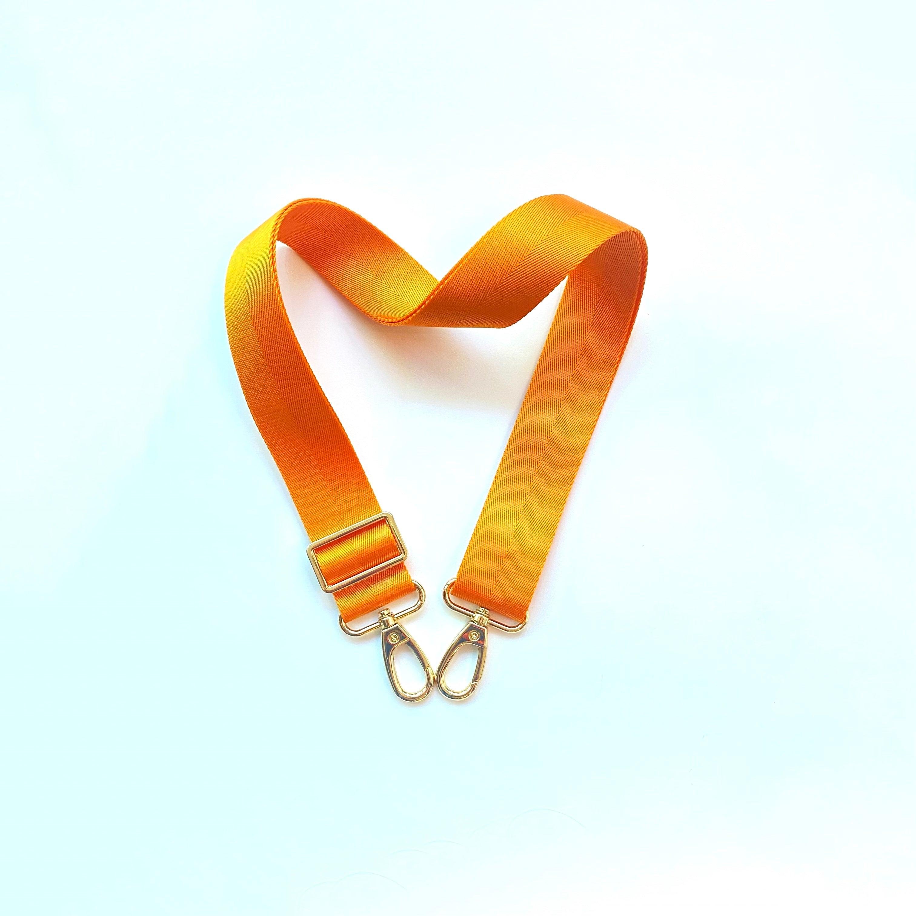 Skyler Blue’s adjustable, nylon webbing knox orange shoulder or crossbody strap with herringbone weave and gold hardware.