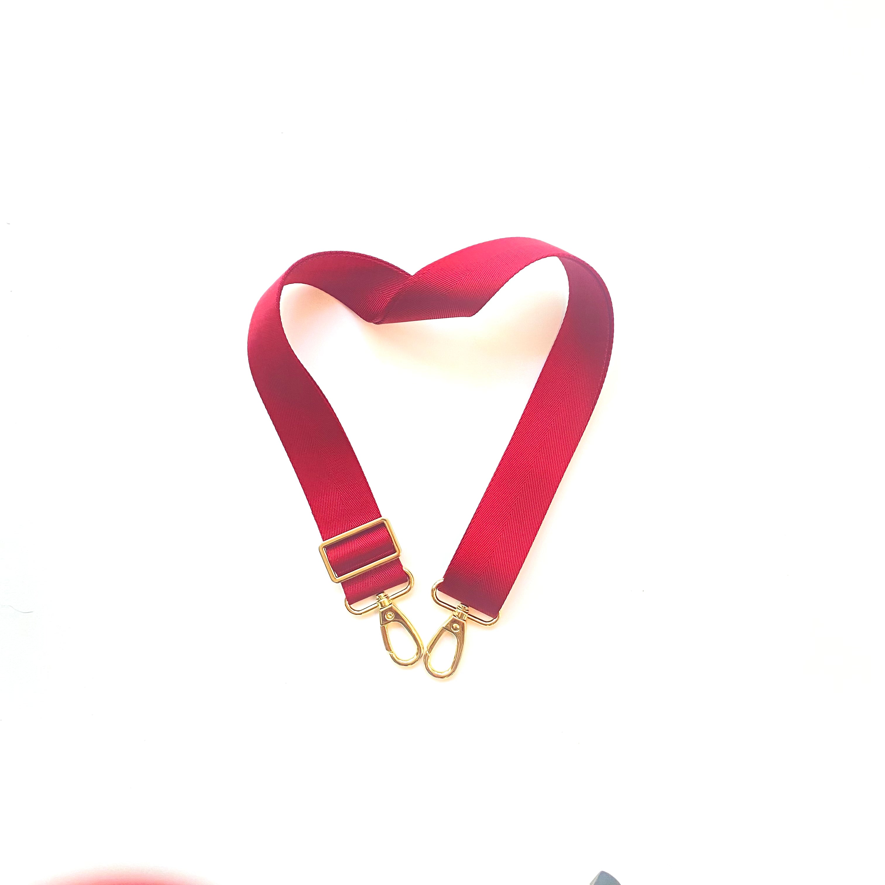 Skyler Blue’s adjustable, nylon webbing crimson red shoulder or crossbody strap with herringbone weave and gold hardware.