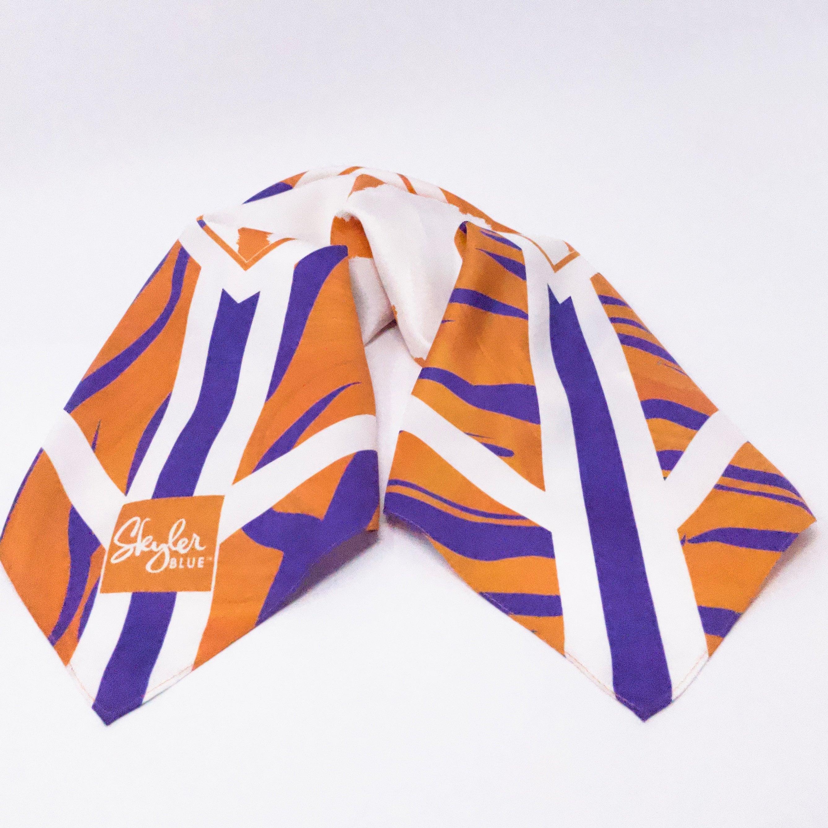 Skyler Blue’s The Howard Accessory Package including adjustable, nylon webbing shoulder or crossbody strap with herringbone weave and gold hardware, 60-centimeter 100% silk twill scarf, and 100% genuine leather tassel.