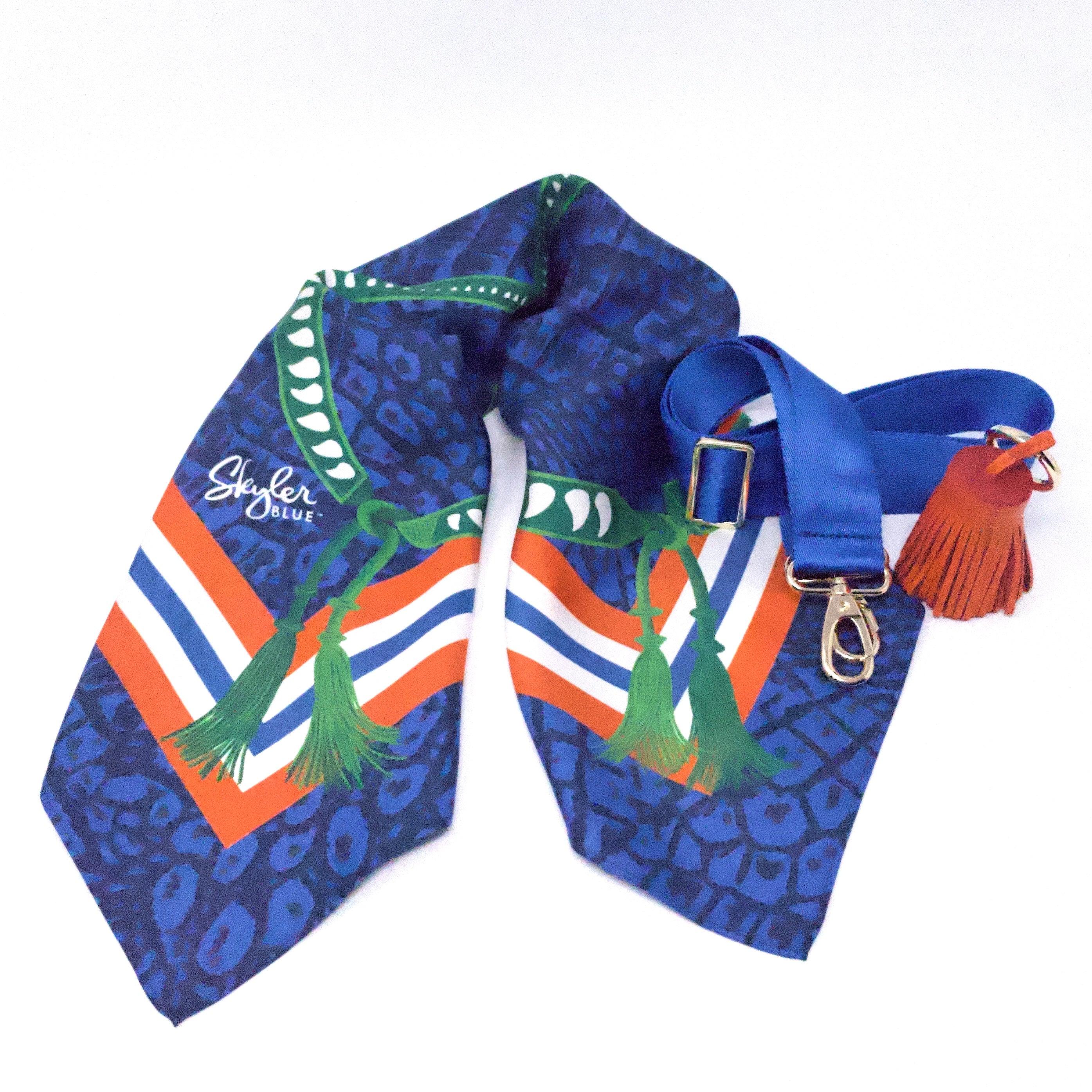 Skyler Blue’s The Gainesville Accessory Package including adjustable, nylon webbing shoulder or crossbody strap with herringbone weave and gold hardware, 60-centimeter 100% silk twill scarf, and 100% genuine leather tassel.