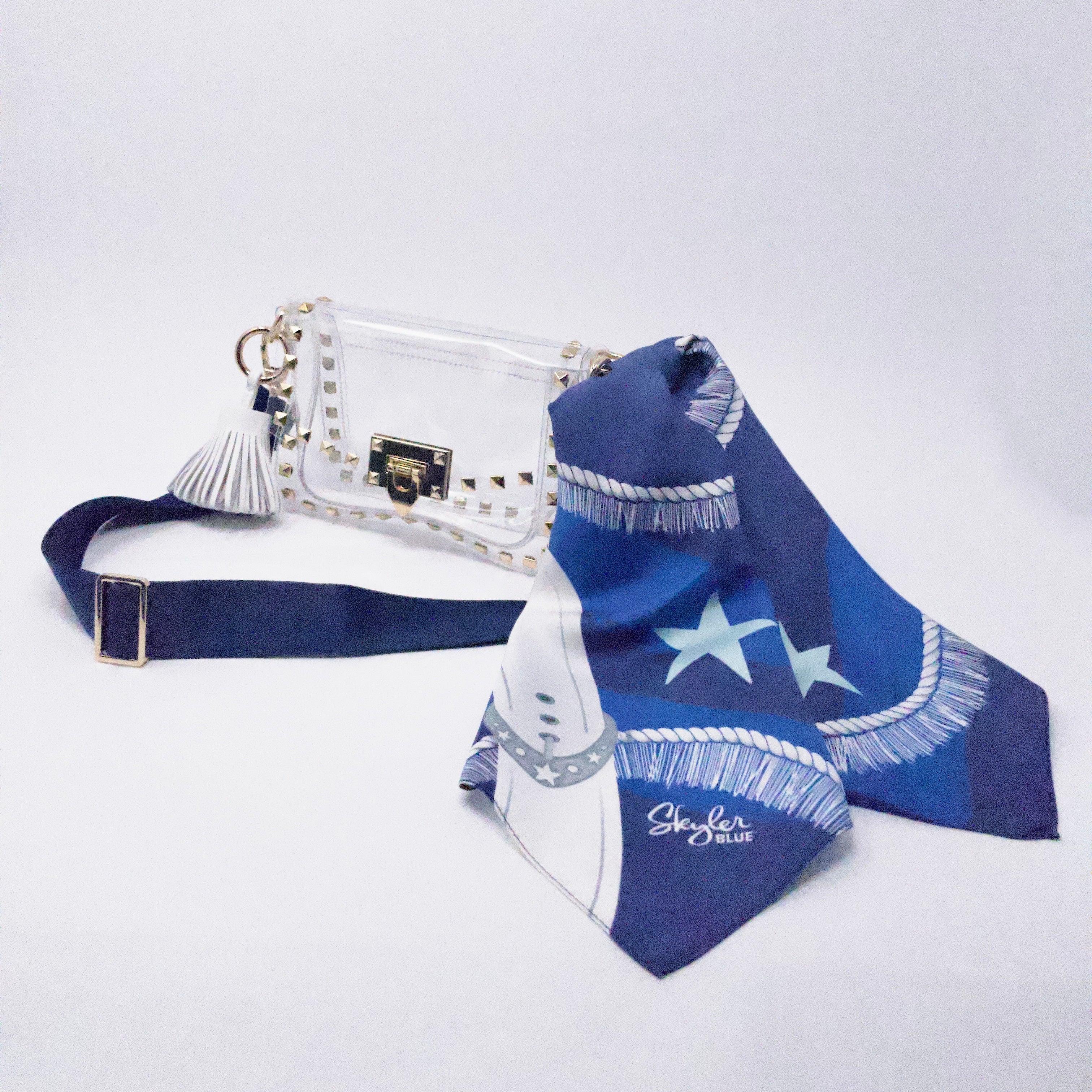Skyler Blue’s The Dallas 002 Small Studded Clear Bag stadium approved clear bag / clear purse including adjustable, nylon webbing shoulder or crossbody strap with herringbone weave and gold hardware, 60-centimeter 100% silk twill scarf, and 100% genuine leather tassel.