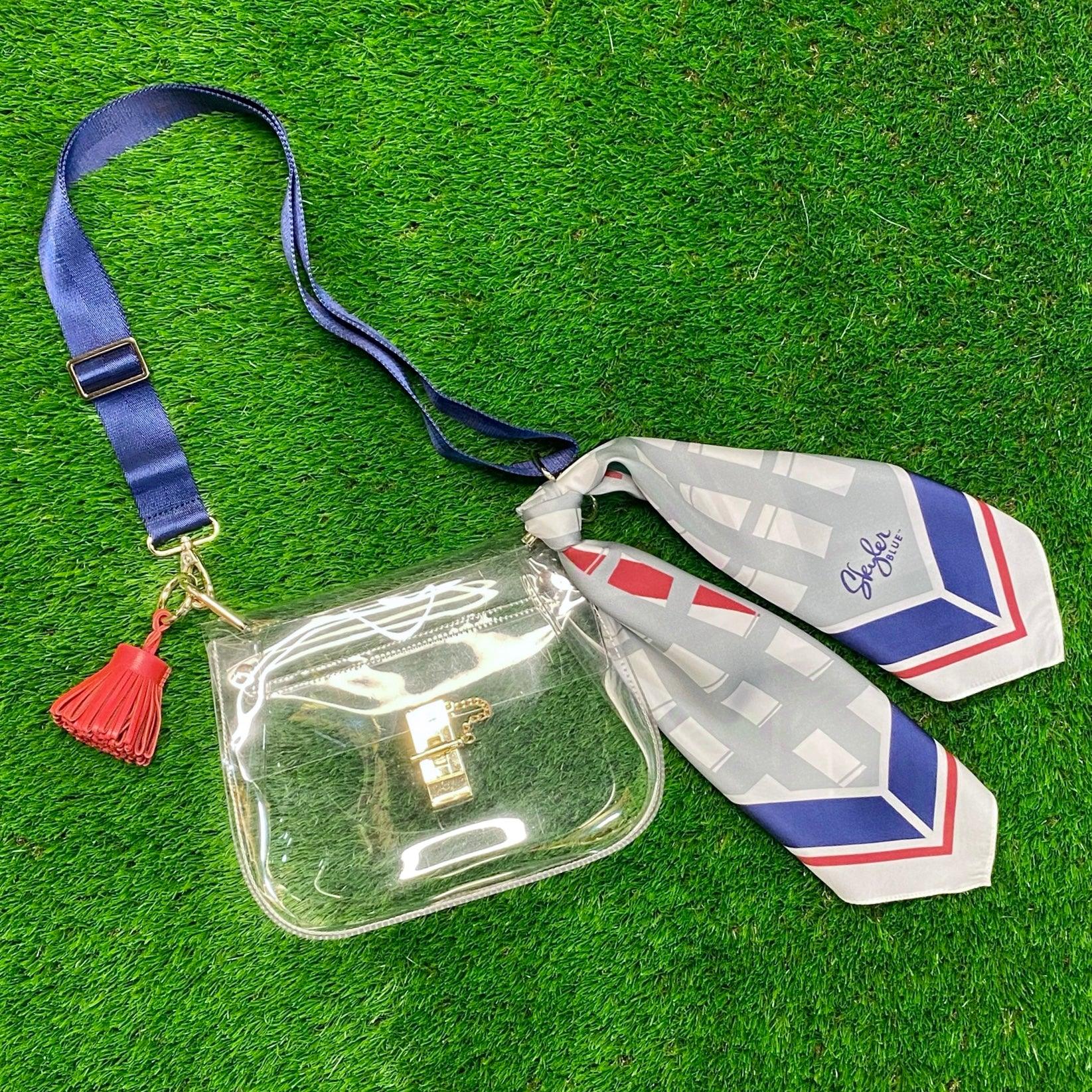 Skyler Blue’s The Dome - Go Texan Day Medium Saddle Clear Bag stadium approved clear bag / clear purse including adjustable, nylon webbing shoulder or crossbody strap with herringbone weave and gold hardware, 60-centimeter 100% silk twill scarf, and 100% genuine leather tassel.