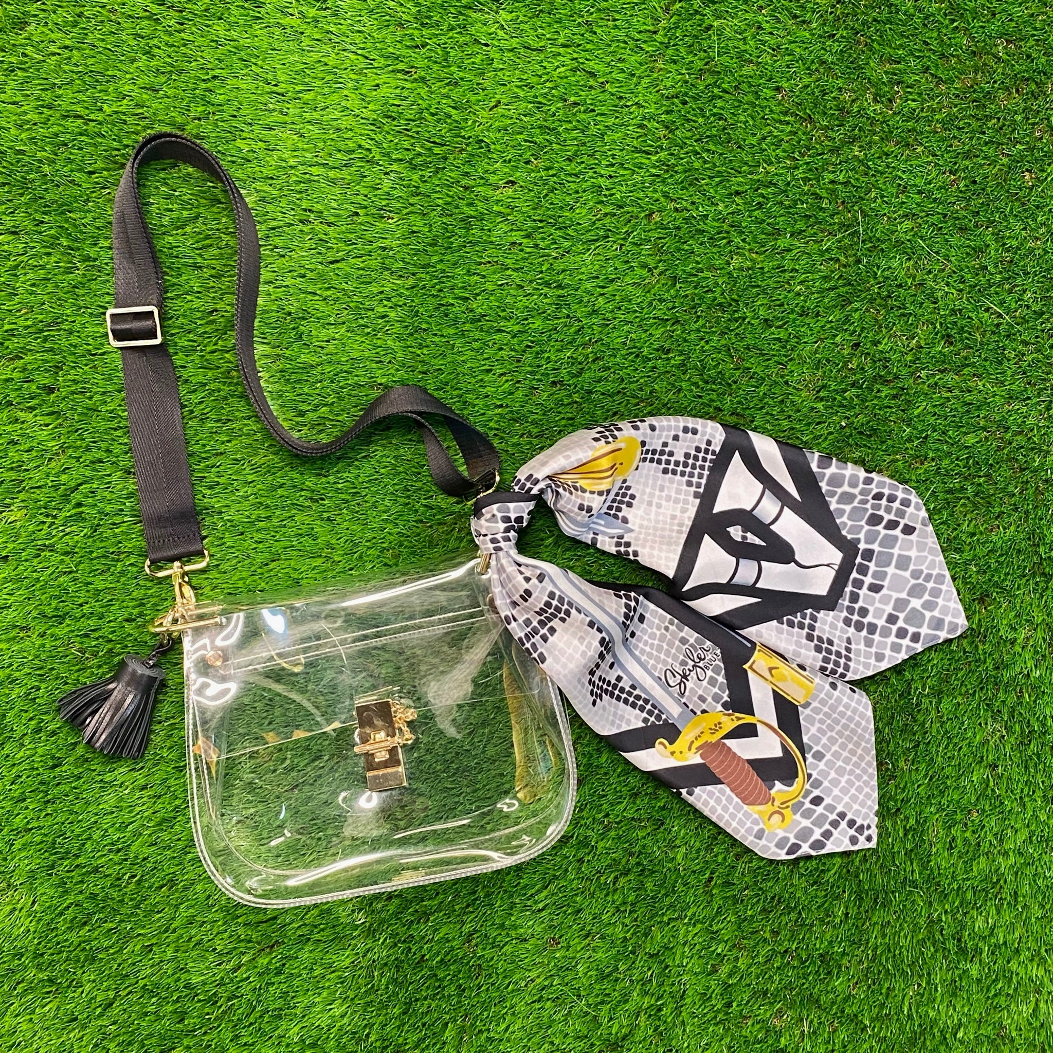 The Vandegrift Medium Saddle Bag, a clear saddle bag purse with a viper snake skin themed custom silk scarf, a black adjustable nylon strap, and a black leather tassel