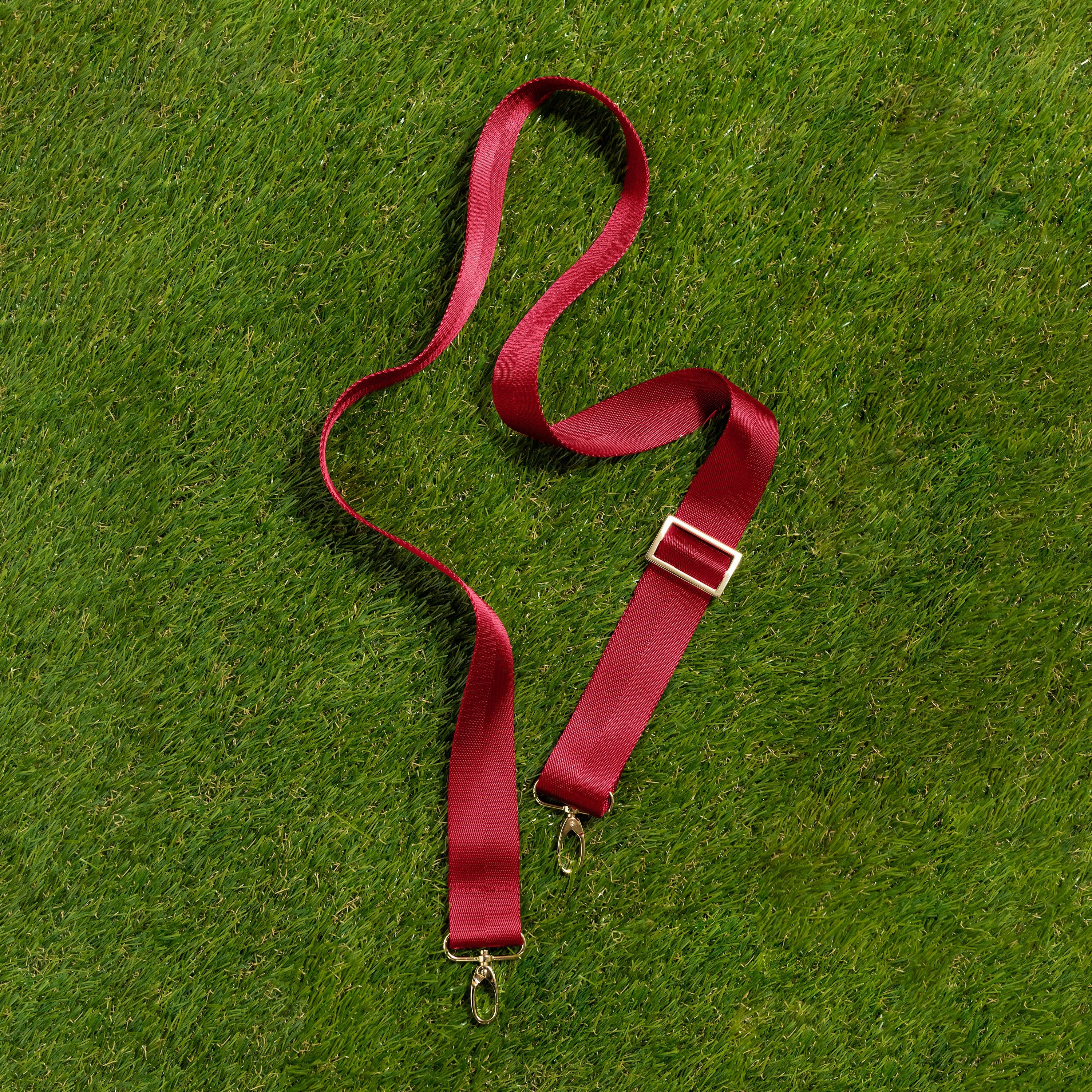 Skyler Blue’s adjustable, nylon webbing crimson red fanny pack strap with herringbone weave and gold hardware.  