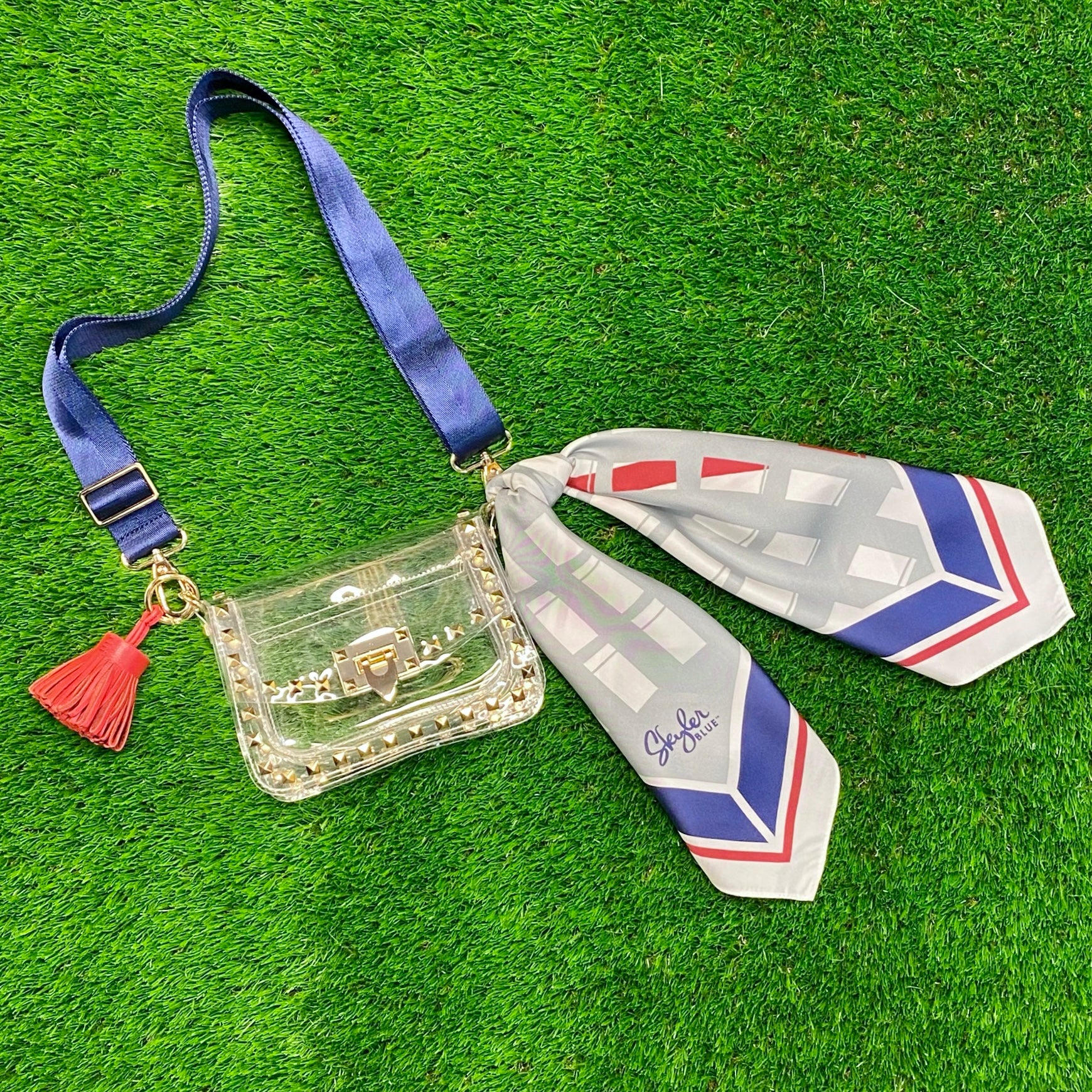 Skyler Blue’s The Dome - Go Texan Day Small Studded Clear Bag stadium approved clear bag / clear purse including adjustable, nylon webbing shoulder or crossbody strap with herringbone weave and gold hardware, 60-centimeter 100% silk twill scarf, and 100% genuine leather tassel. 