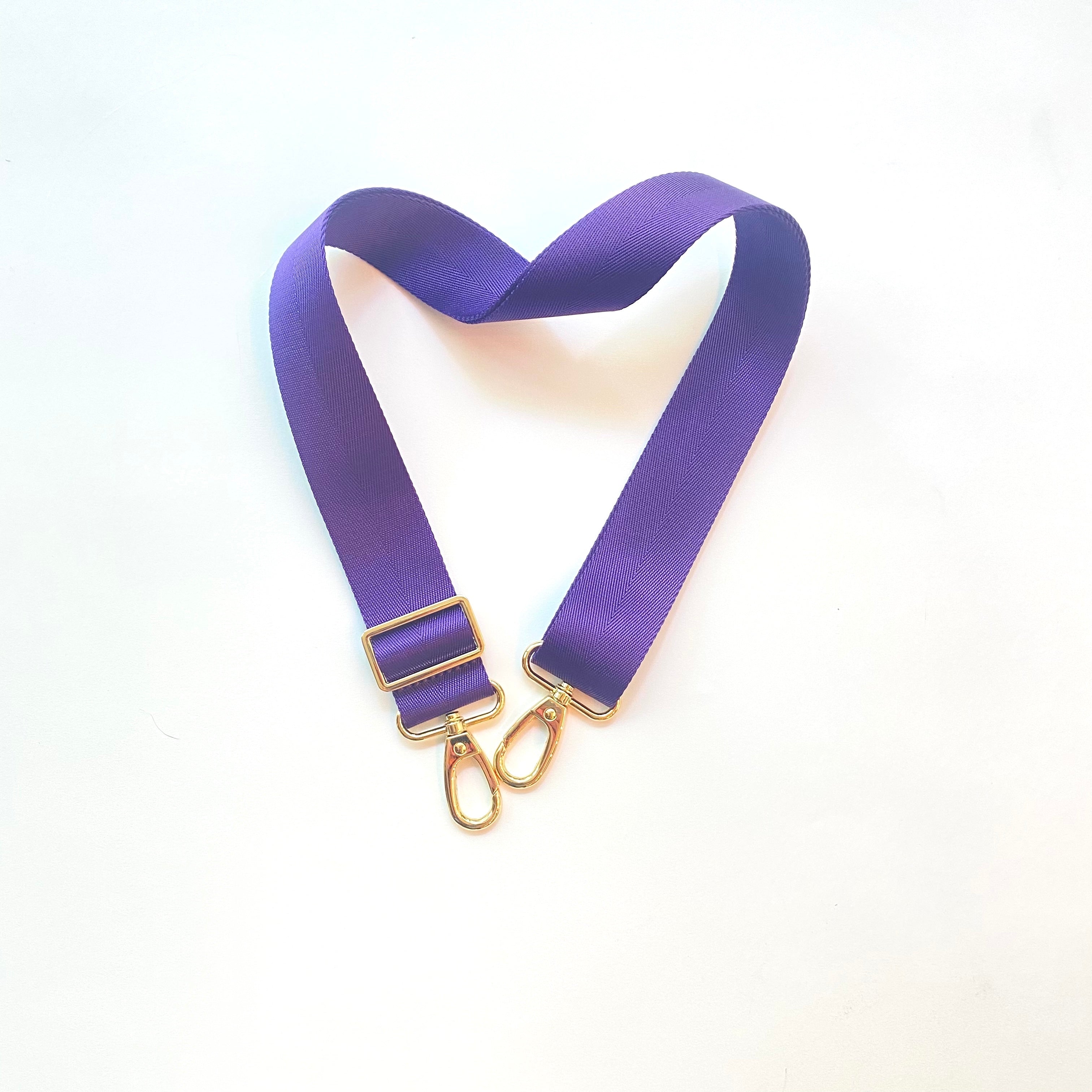 Skyler Blue’s adjustable, nylon webbing purple shoulder or crossbody strap with herringbone weave and gold hardware.  